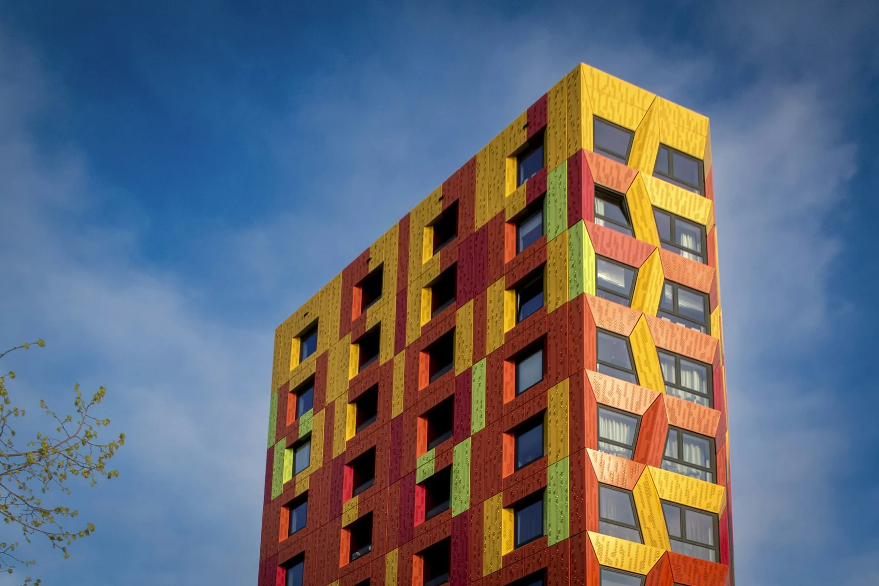 A modern building with a facade of coloured blocks.