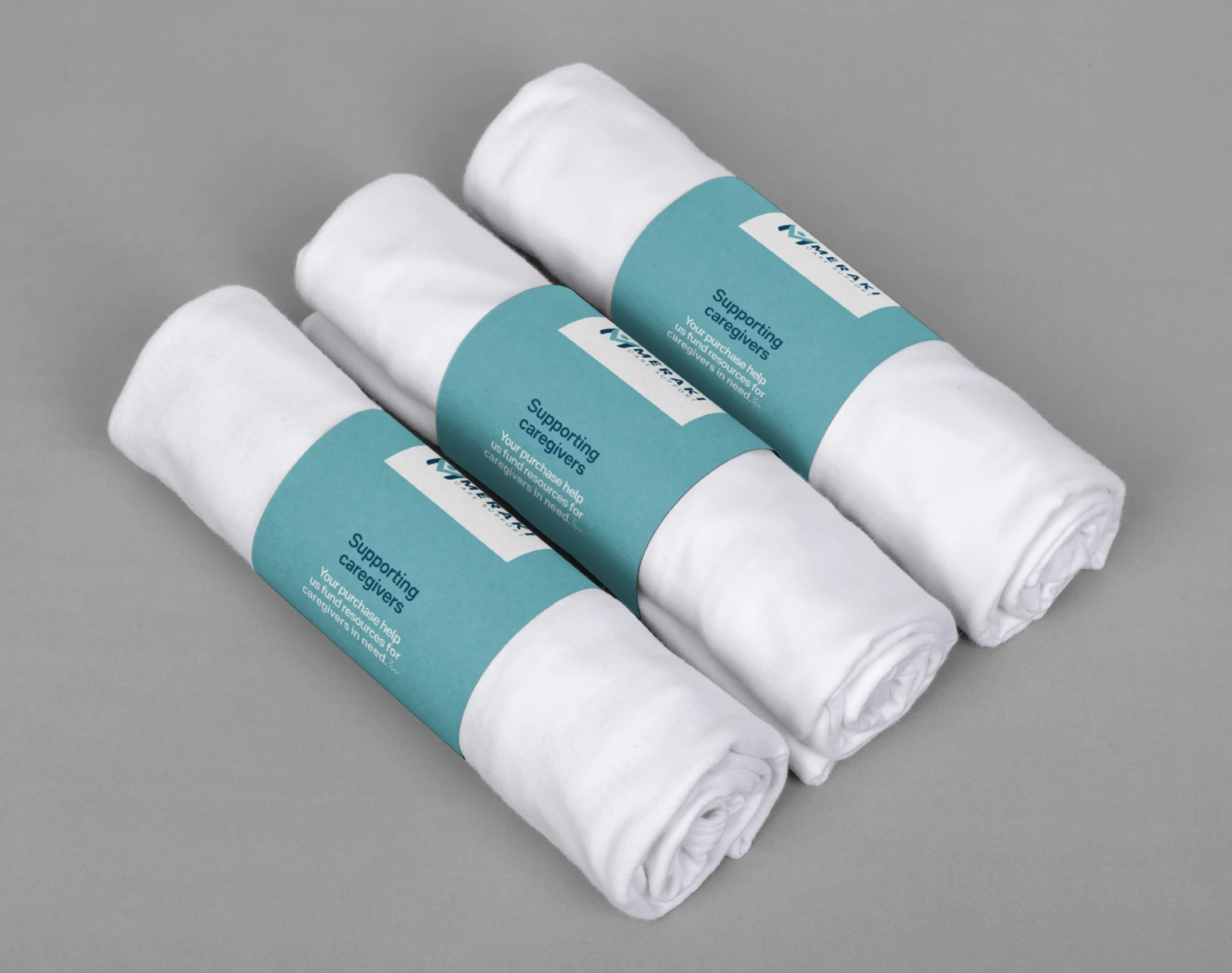 Maeraki rolled towels with teal bands.